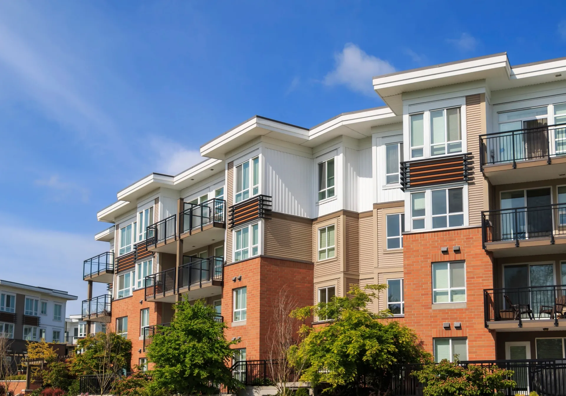Modern residential building with balconies and well-kept outdoor areas